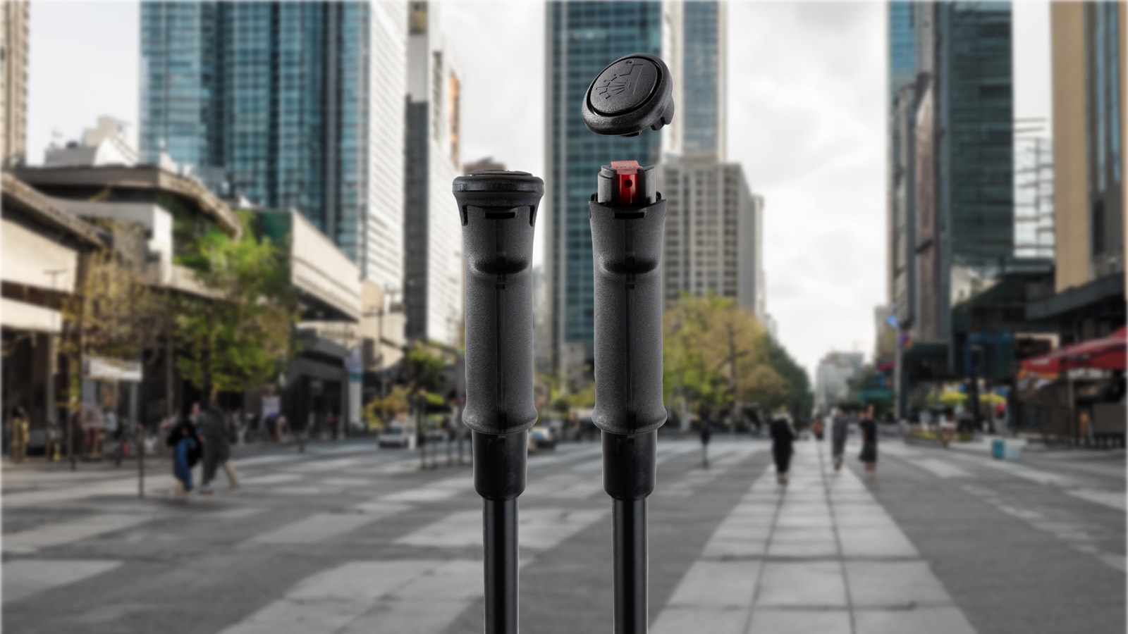 Pepper Poles handles shown on a city street, one capped and one uncapped revealing the red trigger